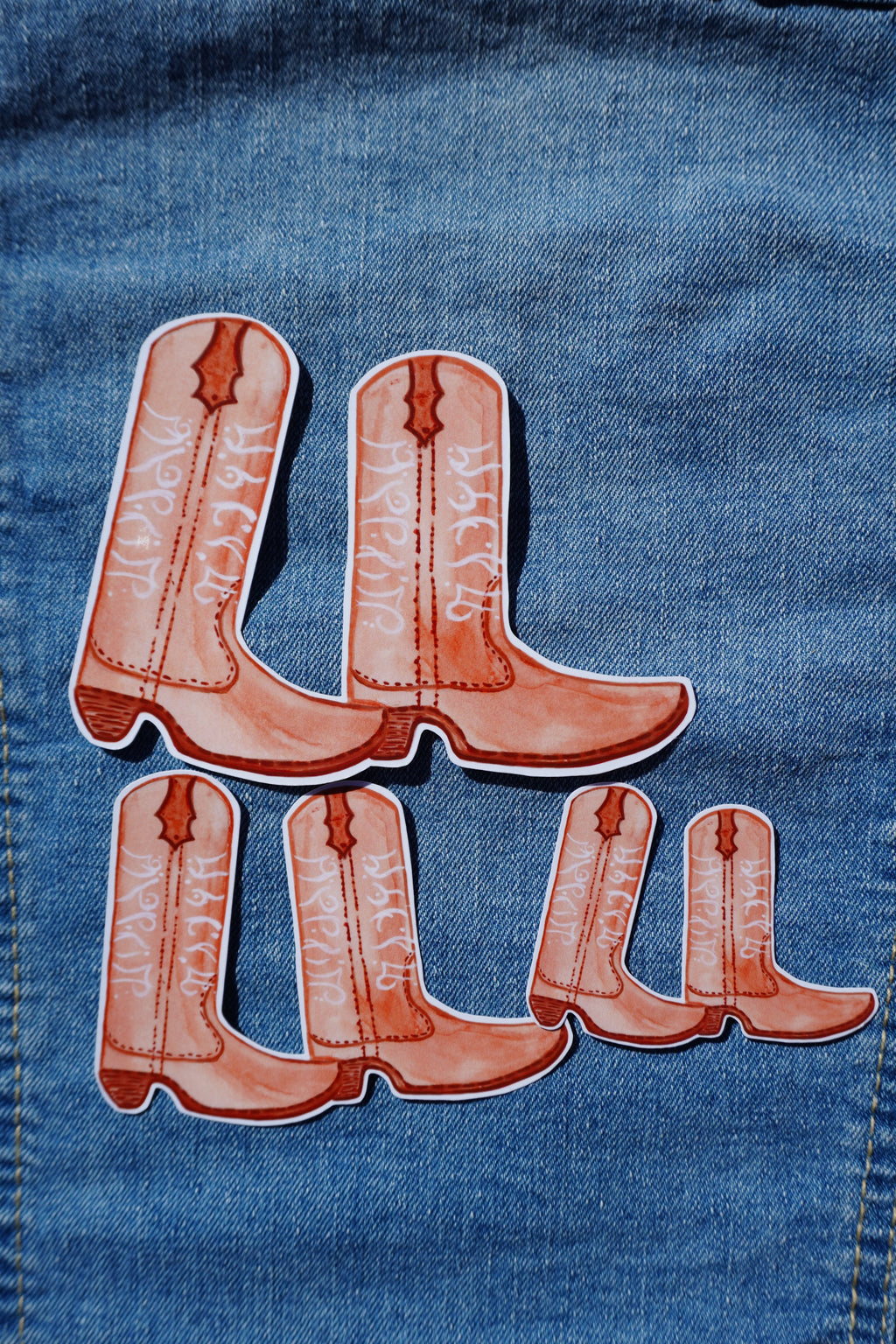 Denim fabric with cowboy boot design and 'Lola' text